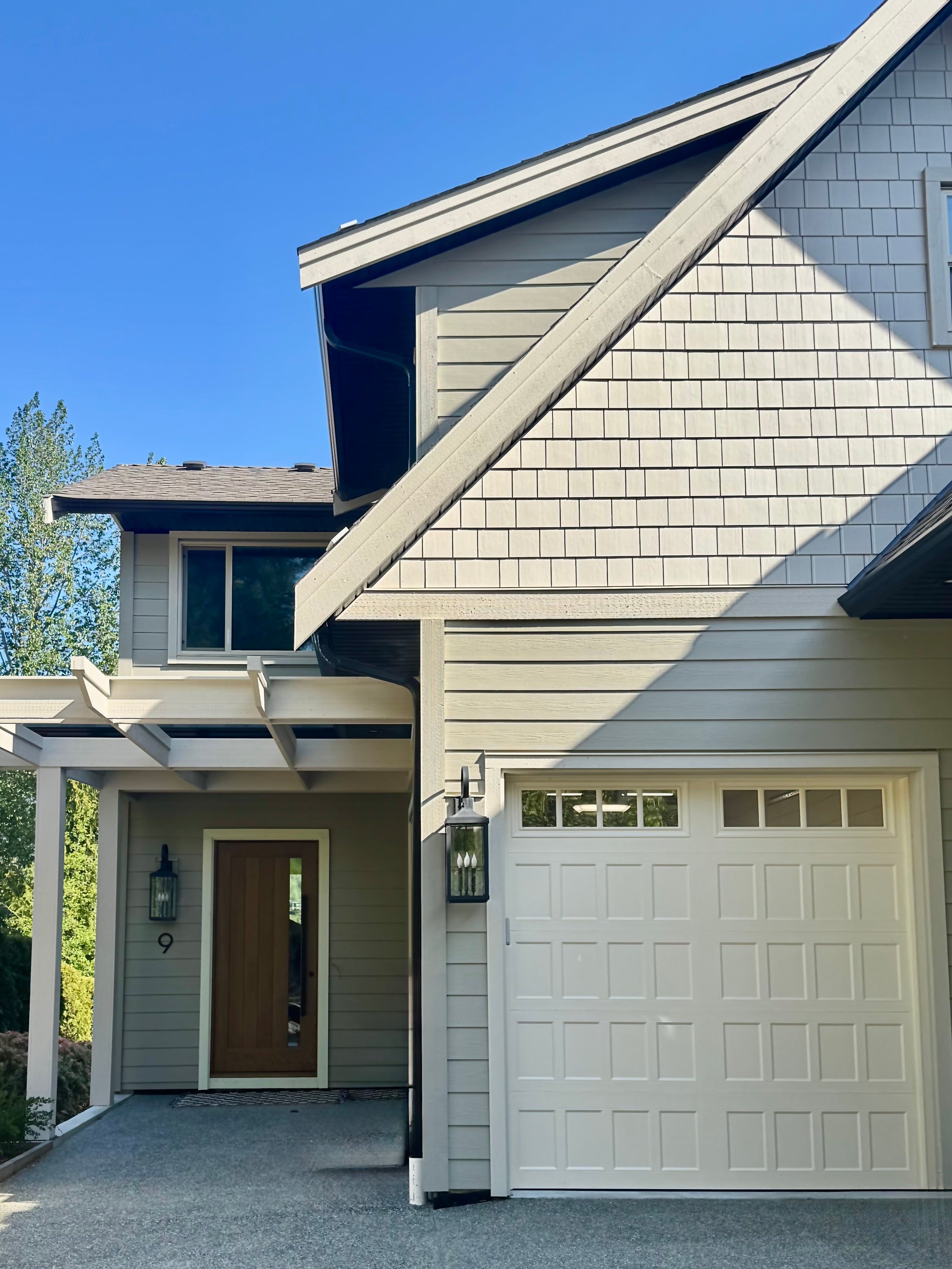 House exterior with garage and driveway on a clear day